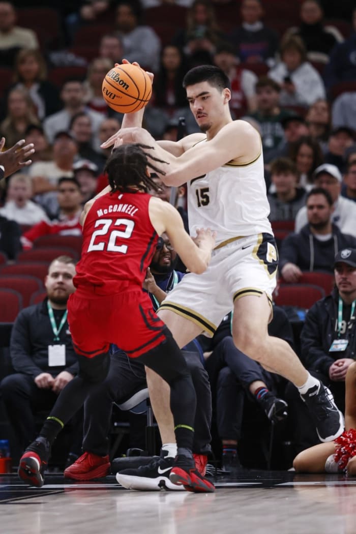 Rutgers Scarlet Knights guard Caleb McConnell (22) defends against Purdue Boilermakers center Zach Edey (15) during the first half at United Center.